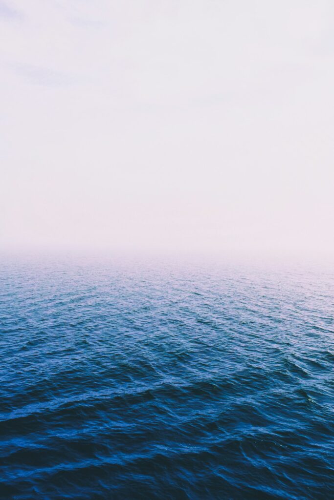 Calm sea fading into soft mist